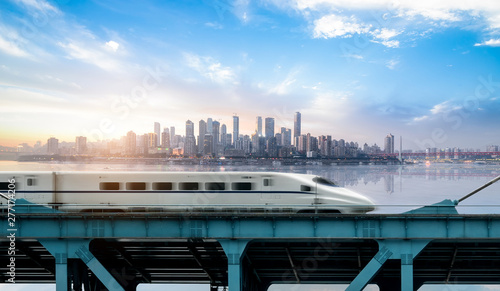 High-speed rail speeds on Bridges and the modern city skyline of chongqing, China photo