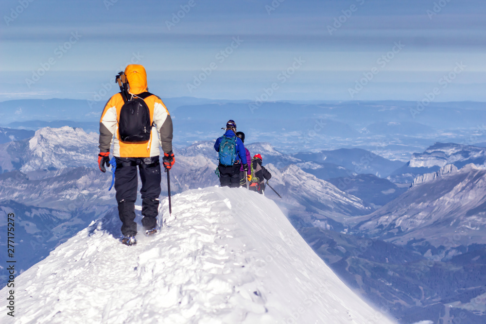 Backpackers climbing a mountain in winter