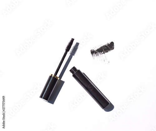 Black mascara close up with brush strokes on the white background. Cosmetic isolated product 
