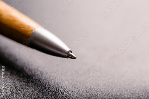 automatic wooden and  plastic ballpoint pen with clipping path on black background. close up.