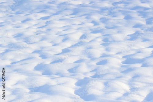 nature background of fresh snow texture in blue tone