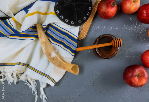 Apple, pomegranate and honey of jewish New Year Rosh Hashana torah book, kippah yamolka talit photo