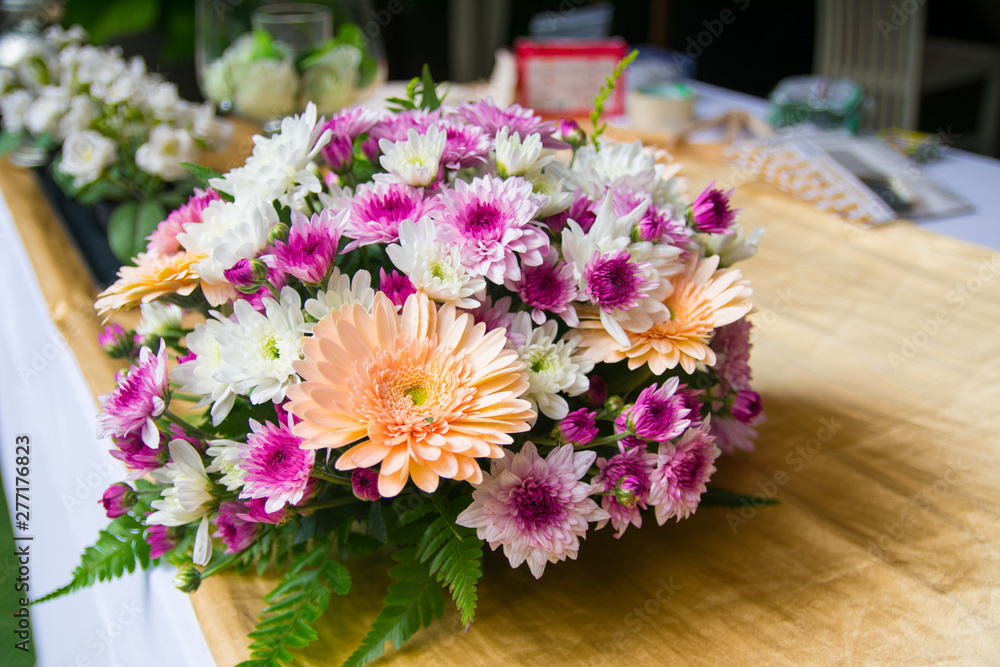 Pink, White and Orange Wedding Bouquet on Wooden Tabletop 