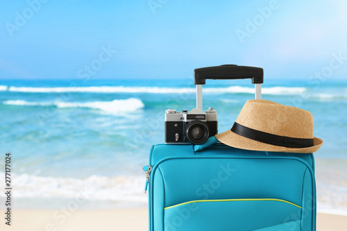 recreation image of traveler luggage, camera and fedora hat infront of tropical background. holiday and vacation concept