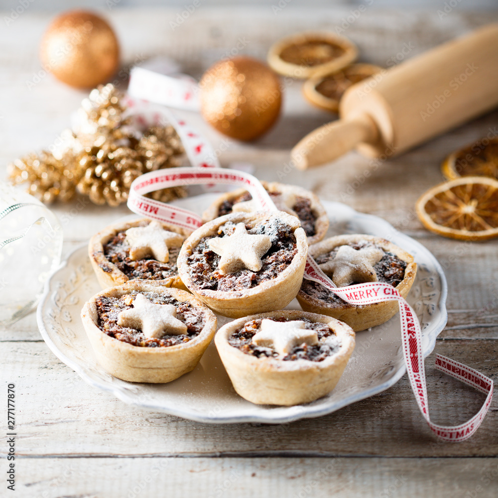 Homemade festive mince pies on white plate Homemade festive mince pies on white plate