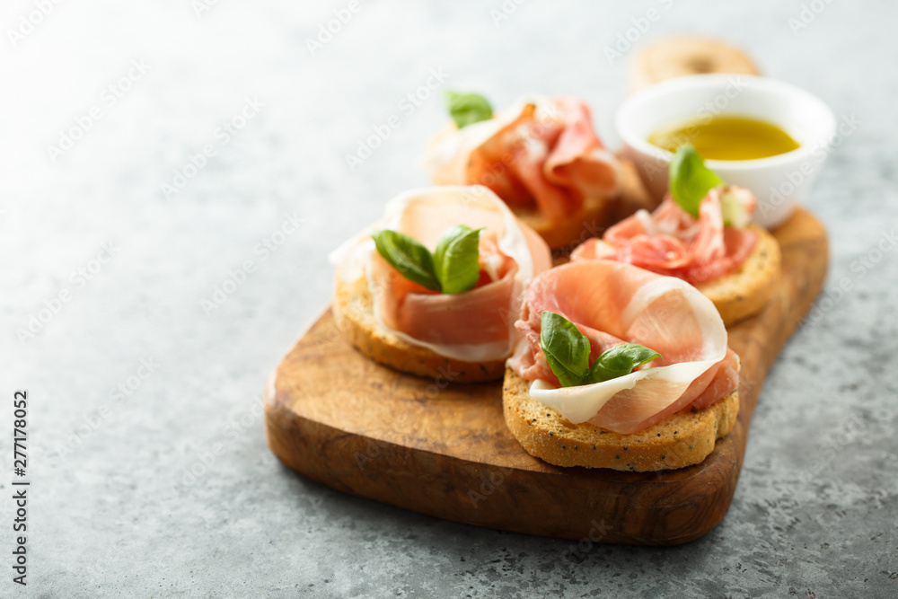 Italian appetizers with Parma ham and basil