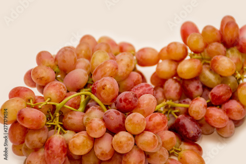 Red ripe grapes on neutral background
