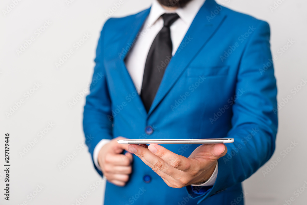 Businessman in blue suite with a tie holds lap top in hands. Businessman in blue suite with a tie holds lap top in hands.
