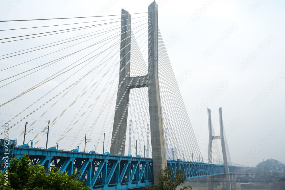 The high-speed train runs at high speed on the railway bridge. The Yangtze River Bridge of Chongqing Railway, China The high-speed train runs at high speed on the railway bridge. The Yangtze River Bridge of Chongqing Railway, China