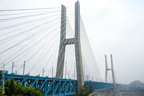 The high-speed train runs at high speed on the railway bridge. The Yangtze River Bridge of Chongqing Railway, China