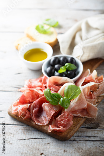 Charcuterie board with fresh basil