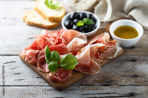 Charcuterie board with fresh basil