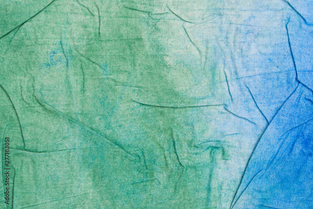 blue and green creased painted textile background