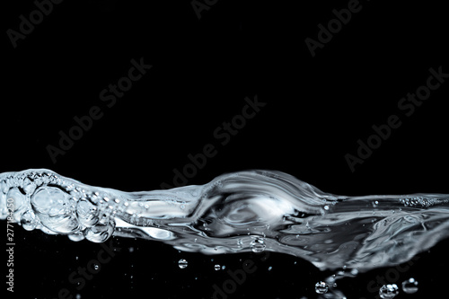 Clear water surface on a black with ripple and bubbles
