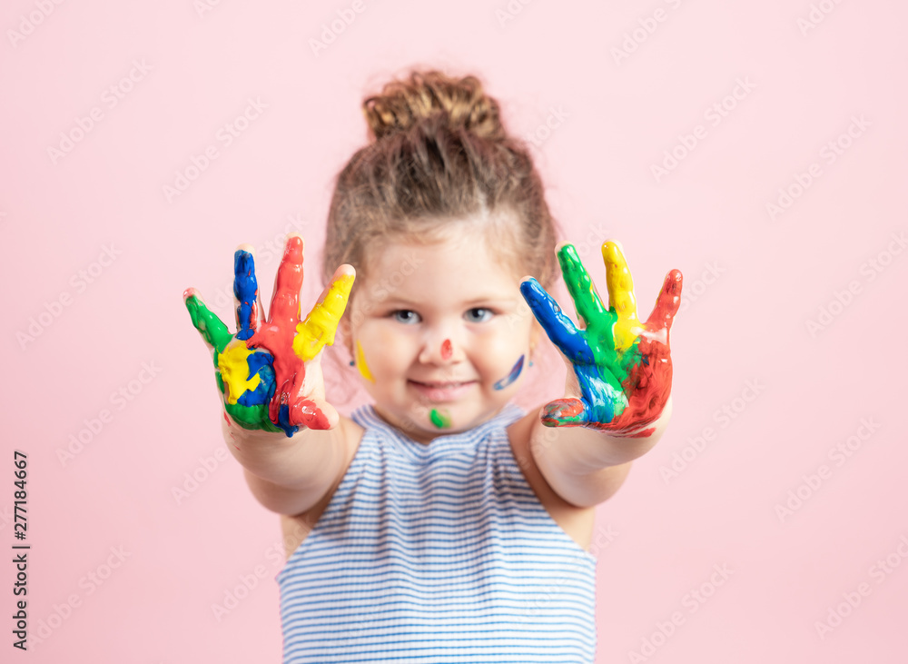 Smiling little girl with hands in the paint on pink background Smiling little girl with hands in the paint on pink background