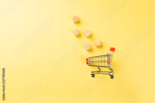 Shopping cart isolated on yellow background