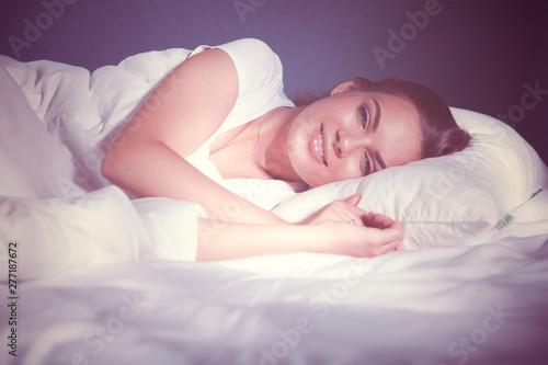 Beautiful young blonde woman sleeping in bed