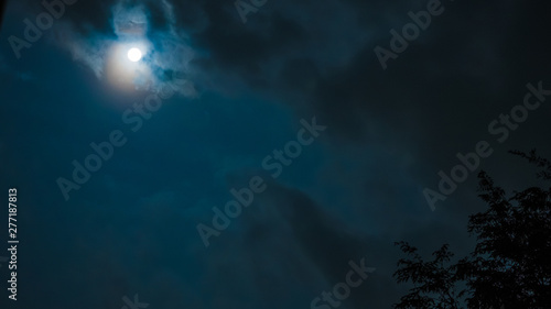 Canvastavla night sky and astronomy on blue background concept from full moon behind the clo