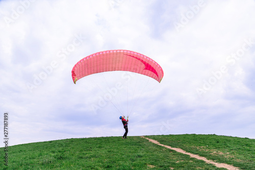 Man landed and tries to drop parachute on ground