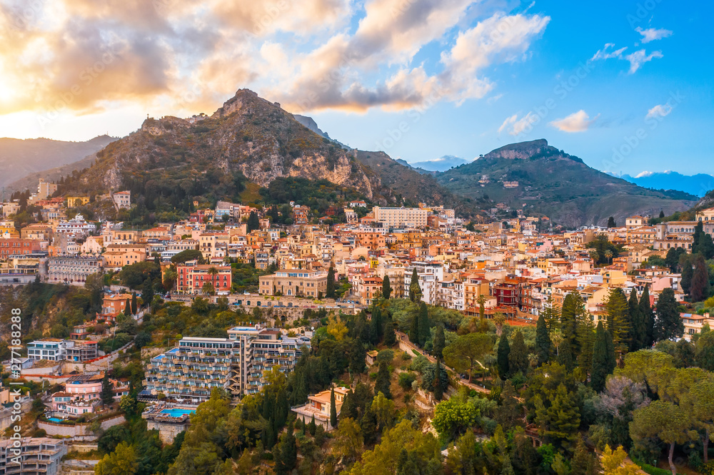 Taormina is a town on the island of Sicily, Italy. Aerial View from above in the evening to temper at the foot of the mountains.