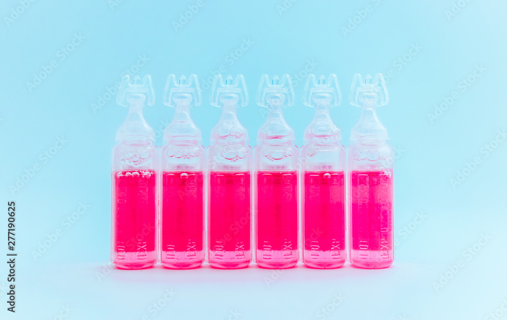 Abstract medical background, an ampoules with pink liquid. Vaccine in bottles background. Abstract medical background, an ampoules with pink liquid. Vaccine in bottles background.