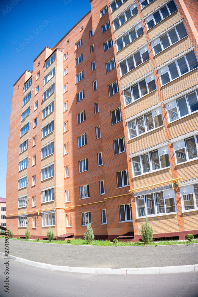 Modern and new apartment building. Multistoried, modern, new and stylish living block of flats. Real estate. New house. Newly built block of flats