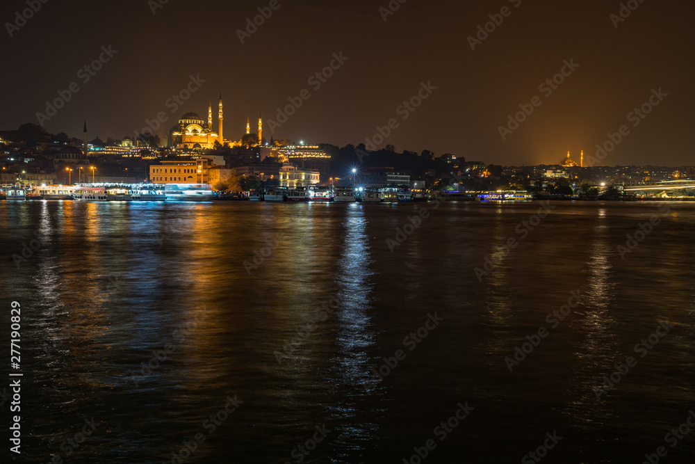 Istanbul night cityscape viewed form Galata Bridge with the illuminated Suleymaniye Mosque, Turkey