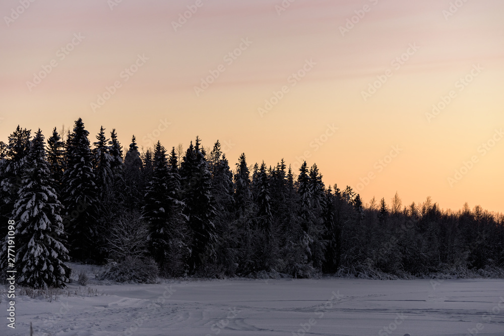 The ice lake and forest has covered with heavy snow and sunset sky in winter season at Holiday Village Kuukiuru, Finland. The ice lake and forest has covered with heavy snow and sunset sky in winter season at Holiday Village Kuukiuru, Finland.