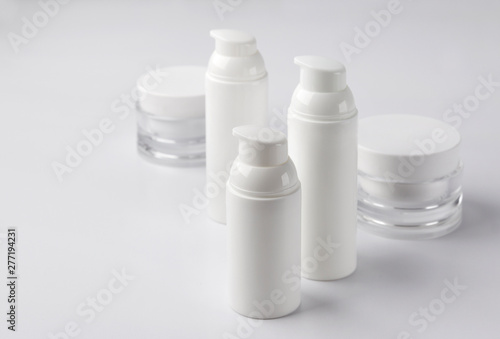 Set of cosmetic cream bottles on white background