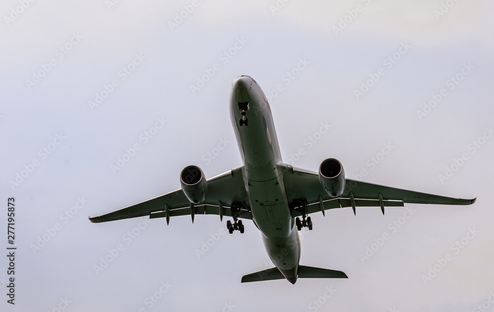 air plane in the blue sky front closeup view air plane in the blue sky front closeup view