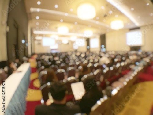 Abstract blurred image of people in seminar room or conference hall for profession seminar and the speaker is presenting new technology with the content activity. education and business concept