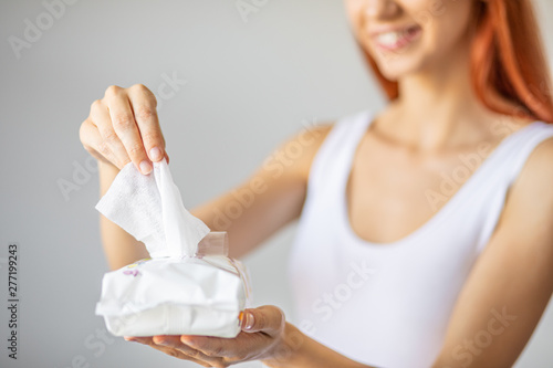 Photos Wet wipes: women take one wipe from package for cleaning