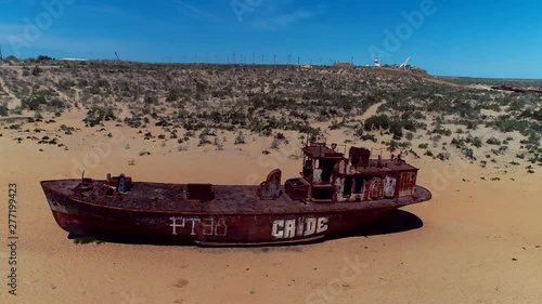 Real model of former sea boat on a pedestal as monument of passed days when Mo'ynoq was an active sea port on Aral sea. Picture taken in former piscatorial port Mo'ynoq Moynaq or Muynak, Uzbekistan. photo