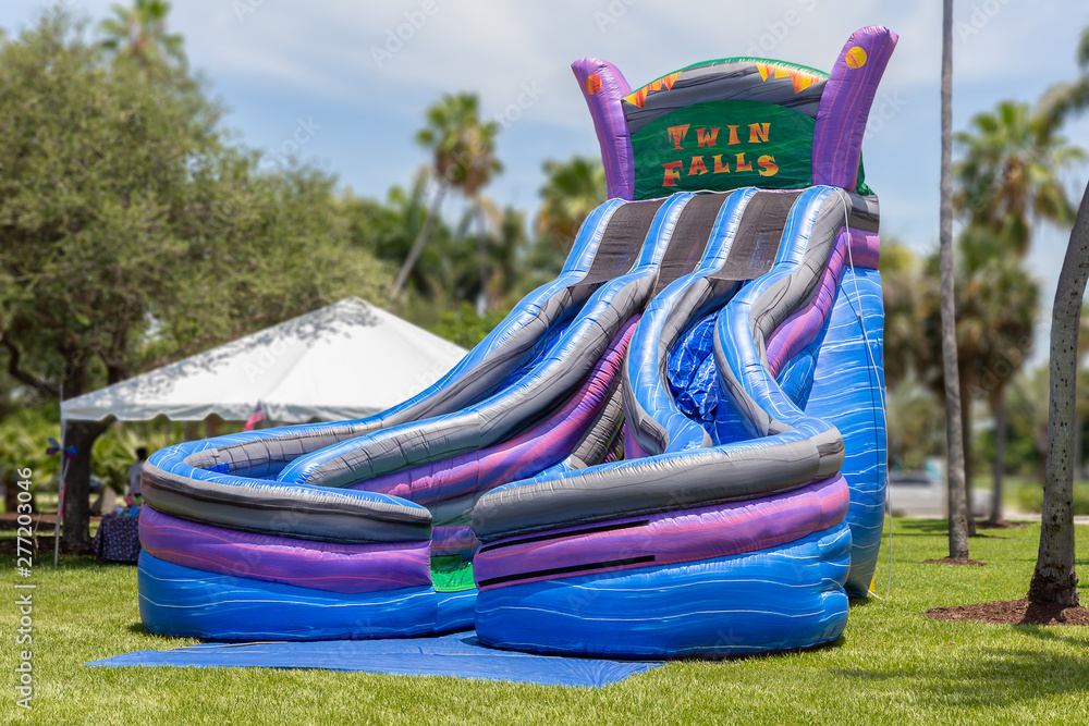 Double the fun with the colorful Twin Falls dual bounce house slides. Double the fun with the colorful Twin Falls dual bounce house slides.