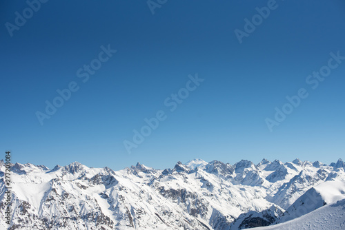 Ridgeline in winter sunny day. Elbrus West Peak view. Dombay ski resort, Western Caucasus, Russia. Wallpaper background minimal concept. Copy Space. © Alla Bacherikova