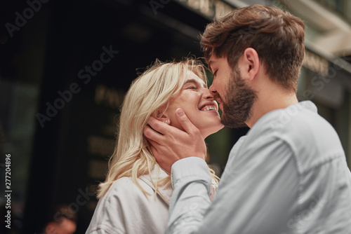 Smiling man is looking at the happy woman