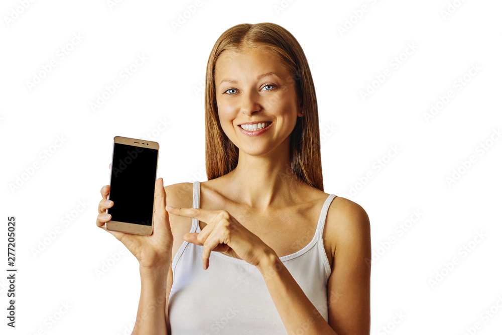 Happy smiling woman points at smartphone, isolated over white background Happy smiling woman points at smartphone, isolated over white background