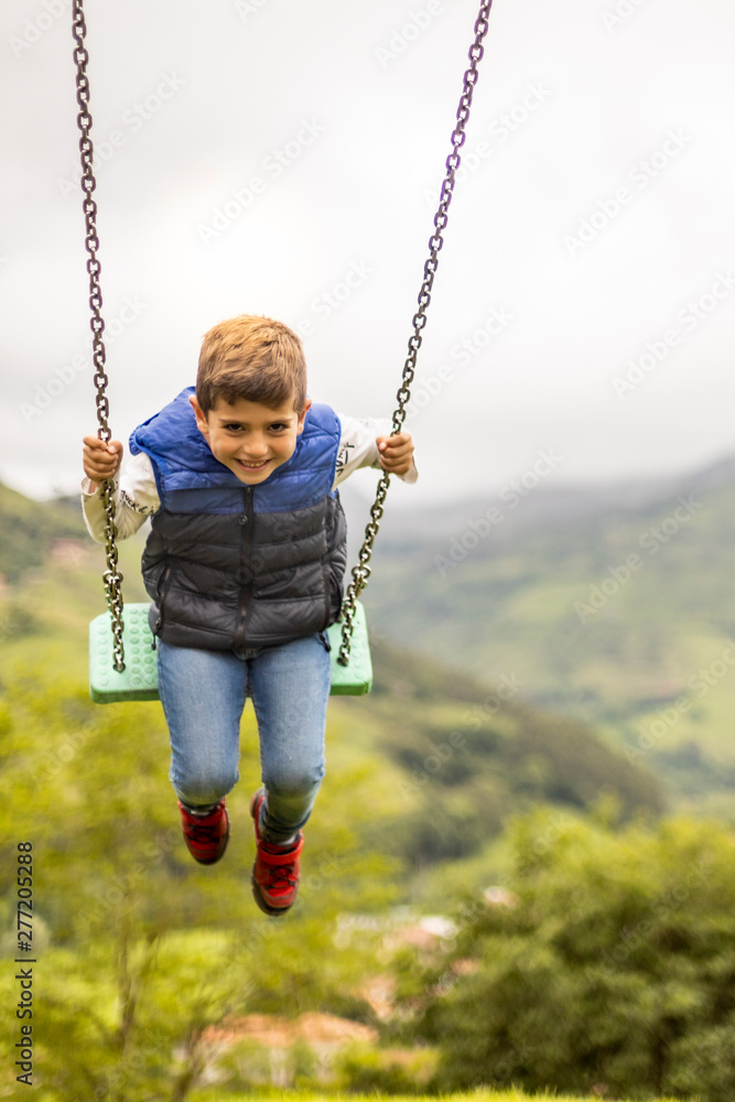 Swinging child on the middle of a field