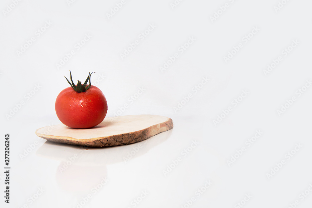 a red tomato on table and wood a red tomato on table and wood