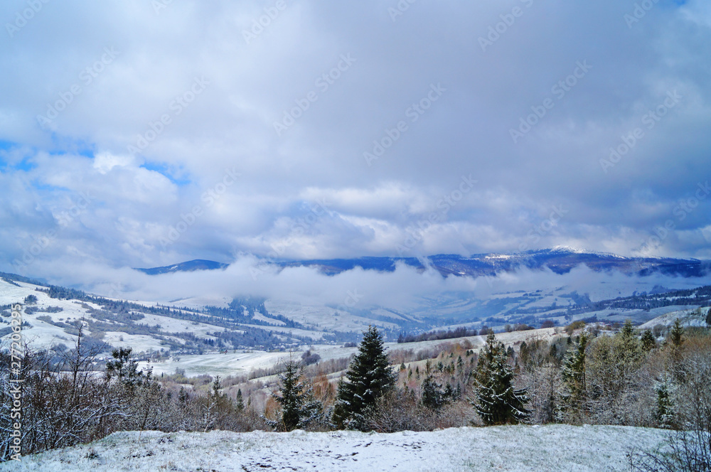 View of the Carpathian mountains covered with snow in a winter sunny frosty day