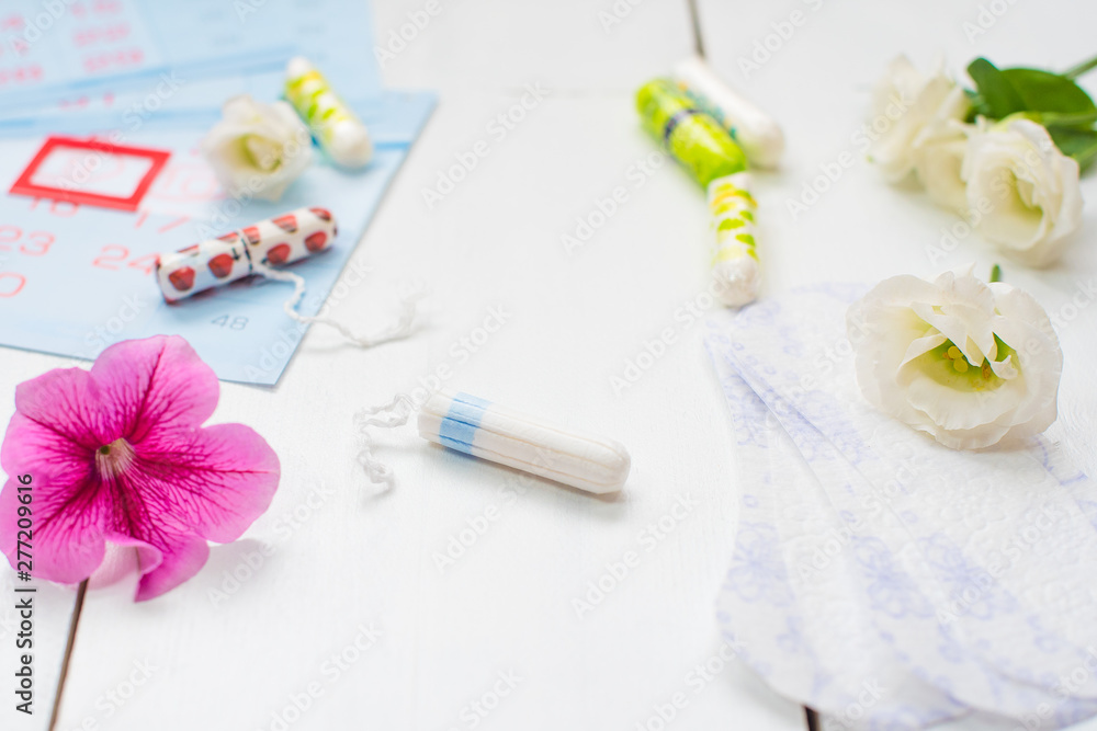 Menstruation calendar with cotton tampons and sanitary pads. Woman critical days, woman hygiene protection Menstruation calendar with cotton tampons and sanitary pads. Woman critical days, woman hygiene protection