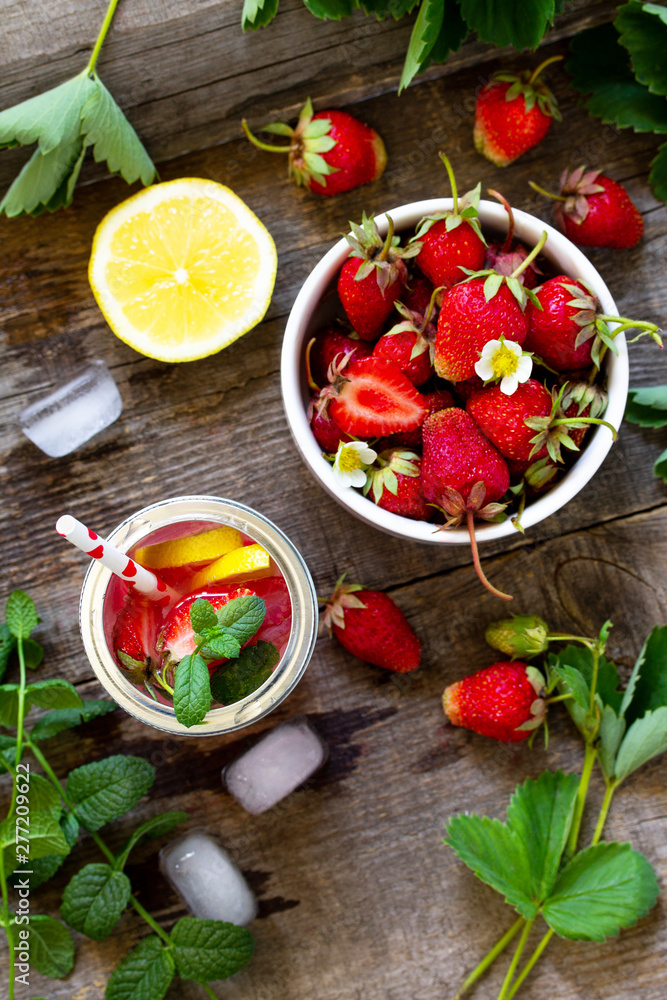 Fresh Strawberry lemonade on rustic wooden table. Top view flat lay background. Free space for your text. Fresh Strawberry lemonade on rustic wooden table. Top view flat lay background. Free space for your text.