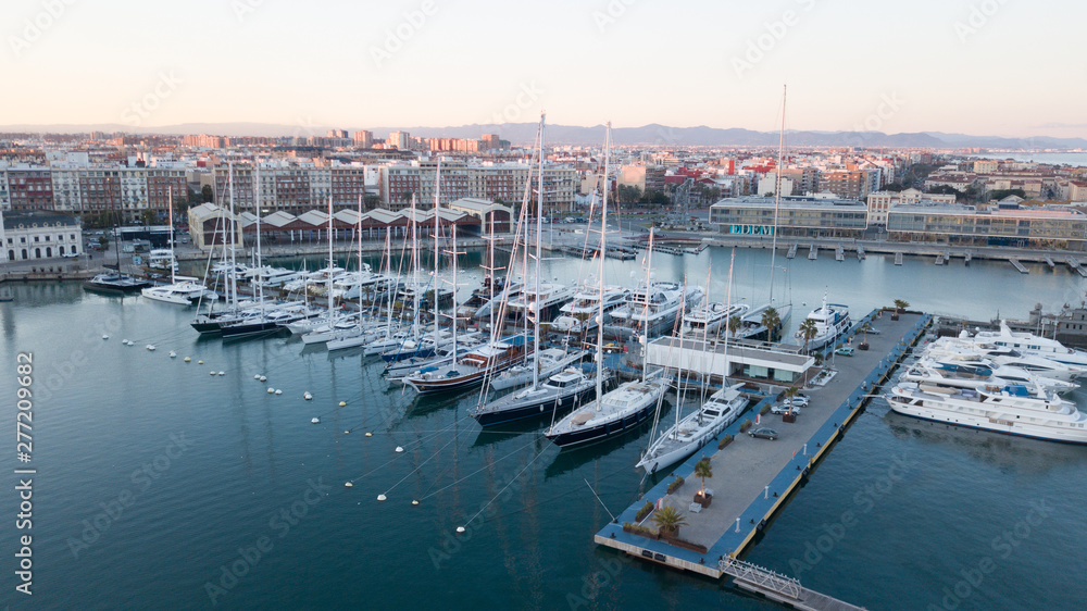 Aerial view of the pier with yachts and boats in the city of Valencia, Spain. Drone photography.