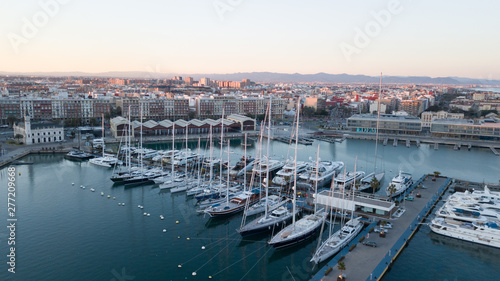 Aerial view of the pier with yachts and boats in the city of Valencia, Spain. Drone photography. © Serega777