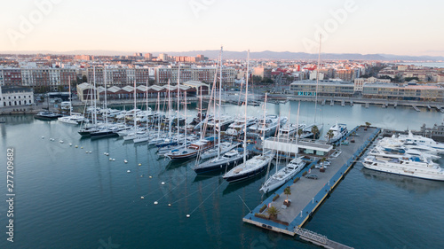 Aerial view of the pier with yachts and boats in the city of Valencia, Spain. Drone photography. © Serega777