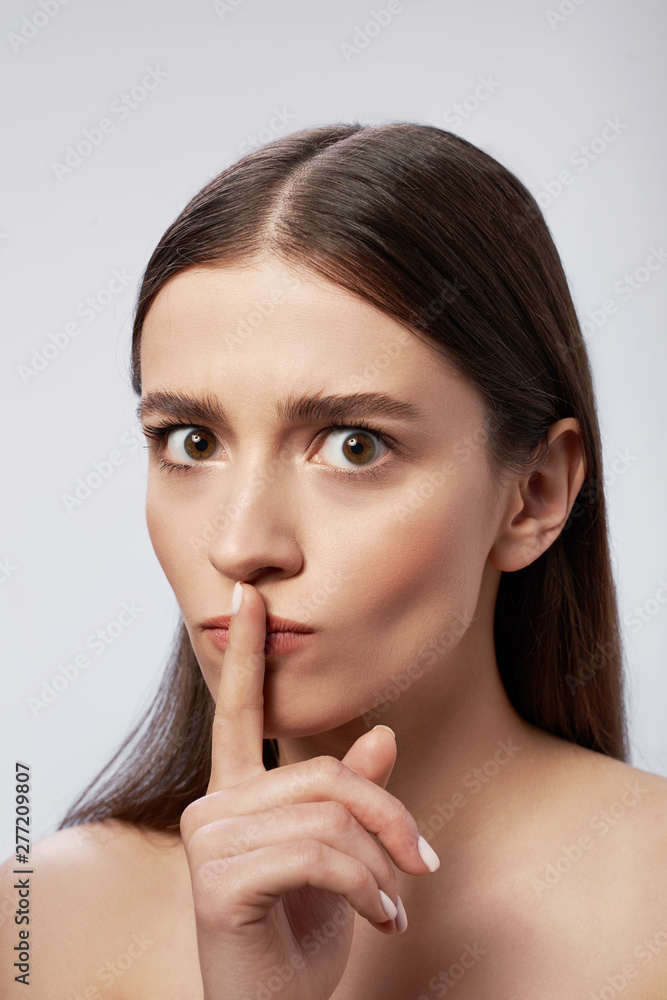 Young lady with perfect skin posing against light gray background Young lady with perfect skin posing against light gray background