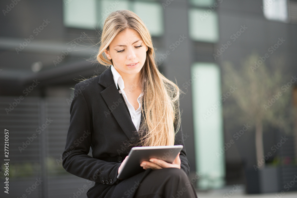 Business woman using her tablet Business woman using her tablet
