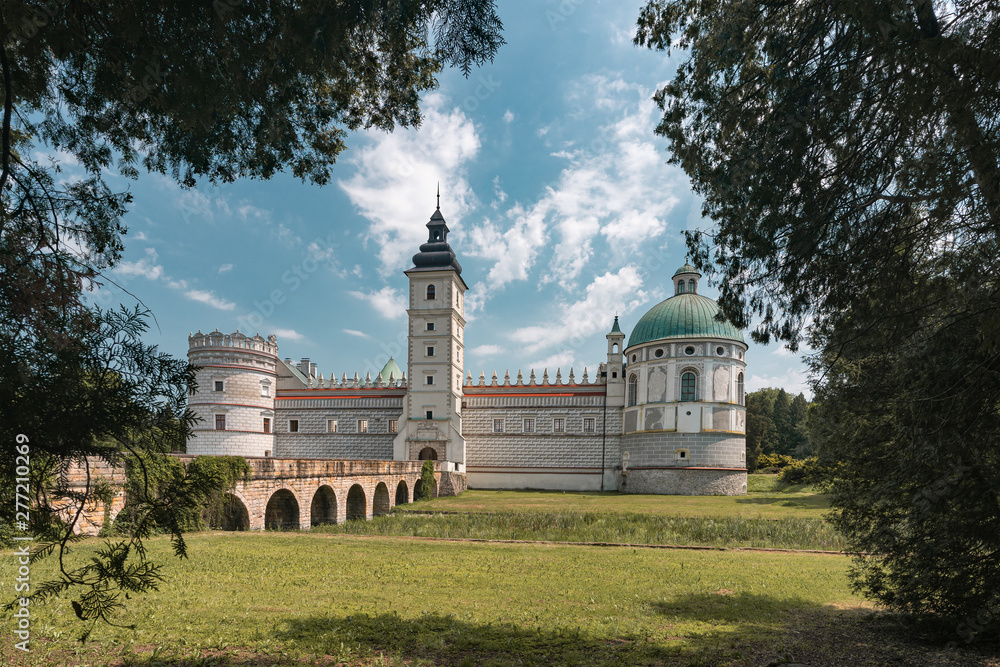View through trees on a late-renaissance castle in Krasiczyn, Poland.