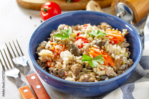 Diet menu. Healthy food. Vegetarian vegetable mushrooms pilaf. Rice with eggplant and mushrooms on stone table.