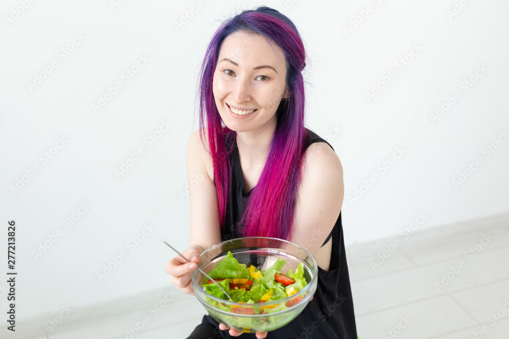Young asian fitness girl with colored hair holding in hands vegetable salad. Healthy eating concept. Young asian fitness girl with colored hair holding in hands vegetable salad. Healthy eating concept.